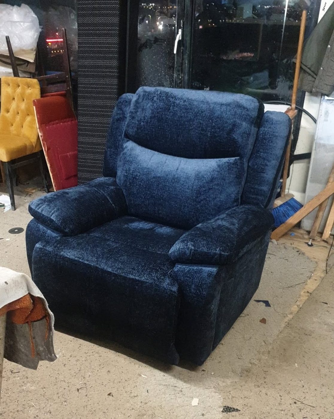 The same recliner after reupholstery in deep navy chenille