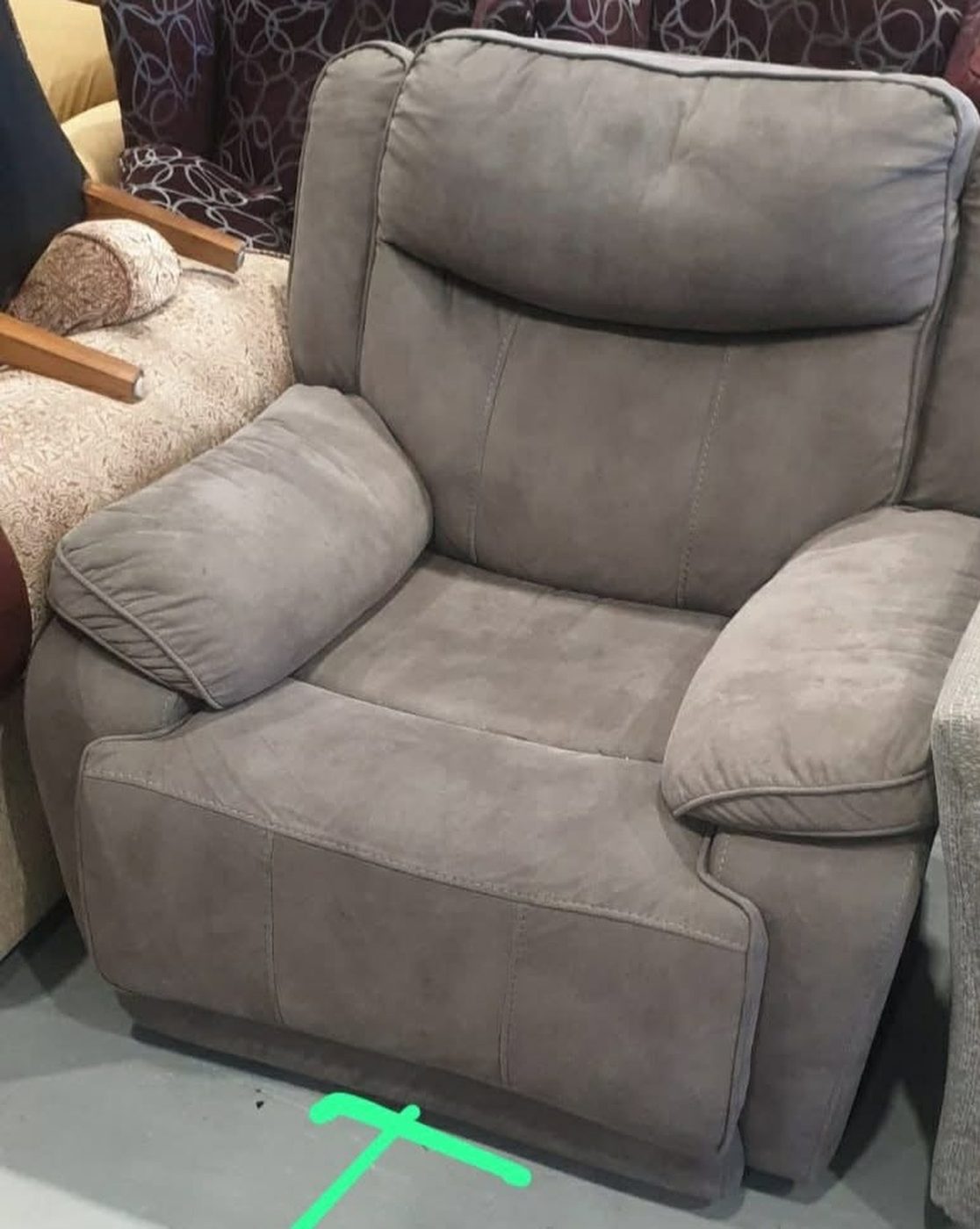 The recliner before: tired grey suede on a concrete workshop floor